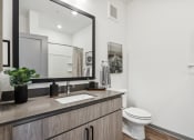 Thumbnail 33 of 40 - a bathroom with a sink and a toilet and a mirror at Stella, San Tan Valley, AZ 85143