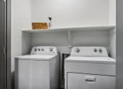 Thumbnail 10 of 40 - a small laundry room with two washes and a dryer at Stella Luxury Apartment Homes, San Tan Valley, AZ, 85143