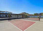 Thumbnail 7 of 40 - a tennis court with a house and a mountain in the background at Stella, San Tan Valley, AZ
