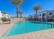 Thumbnail 18 of 40 - our apartments have a large swimming pool with palm trees at Stella Luxury Apartment Homes, San Tan Valley, AZ