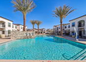 Thumbnail 19 of 40 - our apartments have a large swimming pool with palm trees at Stella Luxury Apartment Homes, San Tan Valley, AZ, 85143