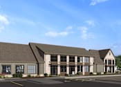 Thumbnail 12 of 16 - A rendering of a modern building with a parking lot in front at The Logan Luxury Apartments, Nampa 83651