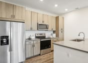 Thumbnail 45 of 49 - a kitchen with stainless steel appliances and wooden cabinets at Drift, Daytona Beach, FL, 32117