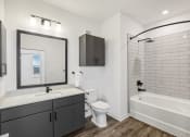 Thumbnail 46 of 49 - a white bathroom with a large mirror and a white tub and sink at Drift, Daytona Beach, FL, 32117