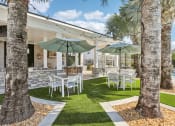 Thumbnail 39 of 49 - a patio with tables and chairs and umbrellas at Drift, Daytona Beach, FL, 32117