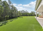 Thumbnail 33 of 49 - a yard with green grass next to a house at Drift, Daytona Beach, FL, 32117