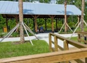 Thumbnail 117 of 124 - Covered pavilion and fishing dock by scenic pond at Velara Luxury Apartments, Florida