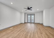 Thumbnail 47 of 58 - an empty living room with white walls and a ceiling fan at Meridian at CityPlace, Woodbury, 55125