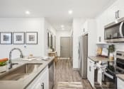 Thumbnail 9 of 56 - a kitchen with stainless steel appliances and white cabinets at Notch66, Longmont, Colorado