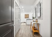 Thumbnail 5 of 56 - a hallway with a door to a kitchen and a table at Notch66, Longmont, Colorado