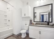 Thumbnail 23 of 56 - a bathroom with white cabinets and a toilet and a bath tub at Notch66, Longmont, Colorado