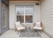 Thumbnail 25 of 56 - a front porch with two chairs and a small table at Notch66, Longmont, Colorado