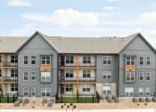 Thumbnail 51 of 56 - an exterior view of an apartment building with stone and gray exterior walls at Notch66, Longmont, Colorado