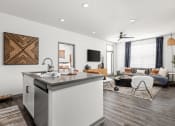 Thumbnail 7 of 56 - a living room with a kitchen and a couch and a tv at Notch66, Longmont, Colorado