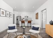 Thumbnail 13 of 56 - a living room with three chairs and a kitchen in the background at Notch66, Longmont, Colorado