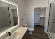 Thumbnail 6 of 17 - A white sink with a mirror above it.