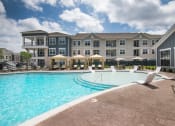 Thumbnail 16 of 56 - Swimming Pool With Lounge Chairs at Watermark at Steele Crossing, Arkansas