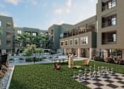 Thumbnail 1 of 21 - A chess board is set up on a grassy area in front of apartment buildings at Refinery at Pointe17 Apartments, Arizona, 85085