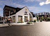 Thumbnail 10 of 45 - A modern building with a bicycle rider in front of it at The Union Flats at Fishers District, Fishers 46037