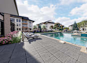 Thumbnail 1 of 16 - A swimming pool surrounded by apartment buildings at The Logan Luxury Apartments, Nampa