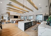 Thumbnail 36 of 45 - the kitchen is open to the living room and dining room at The BLVD at Wilson Crossings, Wyoming, MI