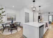 Thumbnail 49 of 58 - an open kitchen and dining area with a table and chairs at Meridian at CityPlace, Minnesota