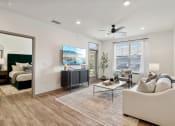 Thumbnail 8 of 88 - an open living room with a couch and a coffee table at The Depot in The Depot Raymore, MO 64083