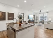 Thumbnail 1 of 88 - an open living room with a kitchen and a living room at The Depot in The Depot Raymore, MO 64083