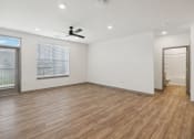 Thumbnail 73 of 88 - an empty living room with white walls and a ceiling fan at The Depot in The Depot Raymore, MO 64083