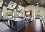 Thumbnail 67 of 88 - a large kitchen with a center island and a living room at The Depot in The Depot Raymore, MO 64083