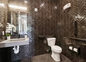 Thumbnail 65 of 88 - a bathroom with a toilet and a sink and a mirror at The Depot Raymore, MO 64083
