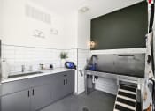 Thumbnail 14 of 88 - a kitchen with stainless steel counters and a sink at The Depot in The Depot Raymore, MO 64083