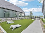 Thumbnail 23 of 88 - the backyard of a house with a lawn and picnic tables at The Depot Raymore, MO 64083