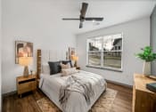 Thumbnail 38 of 45 - a bedroom with a large bed and a ceiling fan at The BLVD at Wilson Crossings, Michigan