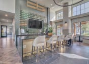 Thumbnail 5 of 30 - a kitchen with a bar with chairs and a television at Canter, Ocala, FL, Florida