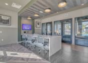 Thumbnail 26 of 30 - a conference room with a desk and chairs and a tv at Canter, Ocala, FL, 34474