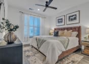 Thumbnail 16 of 30 - a bedroom with a large bed and a ceiling fan at Canter, Florida