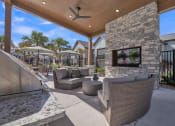 Thumbnail 18 of 30 - common outdoor patio with furniture and a fireplace at Canter, Ocala, FL, 34474