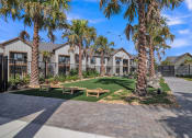 Thumbnail 14 of 30 - a picnic area with benches and palm trees in front of houses at Canter, Ocala, Florida