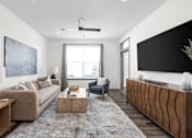 Thumbnail 17 of 36 - A modern living room with a beige sofa, a grey rug, a wooden coffee table, a black and white painting, a grey armchair, a wooden sideboard, and a large window.