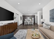 Thumbnail 2 of 36 - A modern living room with a wooden coffee table and a large couch.