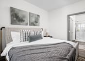 Thumbnail 18 of 36 - A bedroom with a large bed and two paintings on the wall.