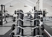 Thumbnail 34 of 36 - A gym with a row of weight machines.