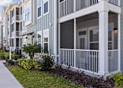 Thumbnail 10 of 36 - A row of townhouses with white railings and balconies.