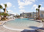 Thumbnail 21 of 36 - A large swimming pool in front of a resort.