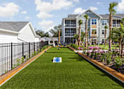 Thumbnail 37 of 37 - A grassy area with cornhole gamein the middle at Standard441 Luxury Apartments, Florida