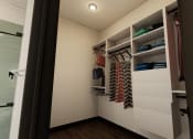 Thumbnail 14 of 40 - a walk in closet in a bathroom with white walls and shelves at Stella, San Tan Valley, AZ 85143