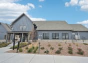 Thumbnail 1 of 53 - the front of a blue house with a landscaped front yard at The Garrison Luxury Apartment Homes, Fountain