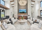 Thumbnail 23 of 53 - a living room with couches and a fireplace at The Garrison Luxury Apartment Homes, Fountain, CO 80817