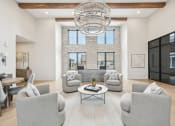 Thumbnail 2 of 53 - a living room with couches and chairs and a chandelier at The Garrison Luxury Apartment Homes, Colorado, 80817